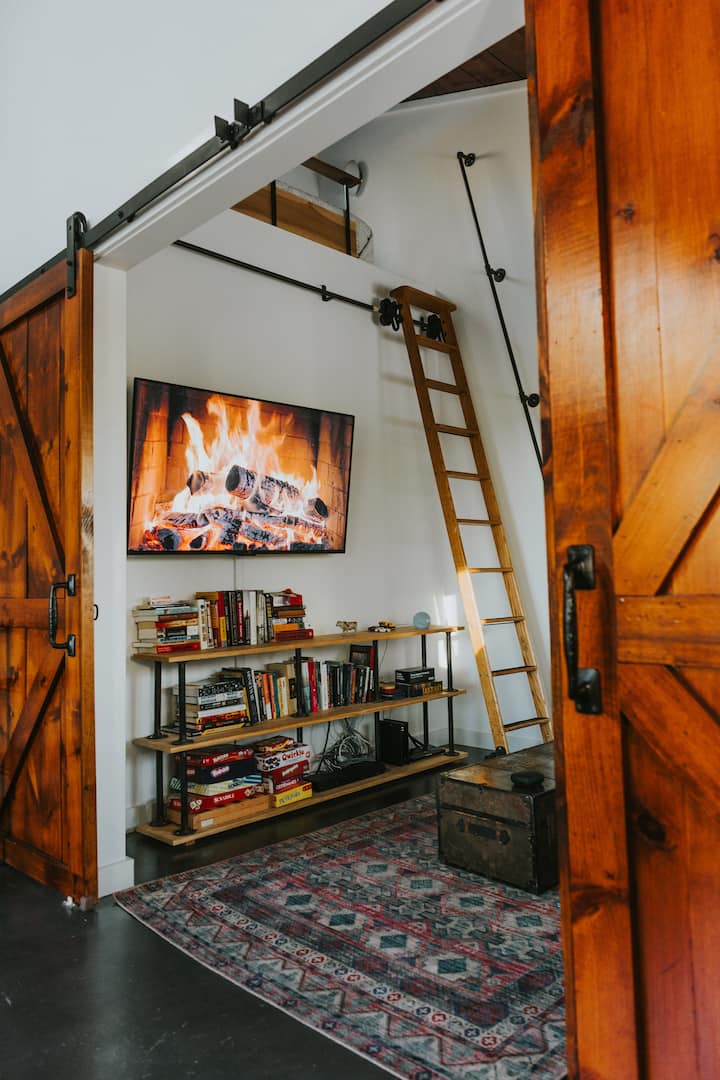 Bedroom #3 - view of the library ladder leading up to the loft sleeping area. Additionally, there are ample games, books, a smart TV and an Amazon Echo Dot for fun and entertainment!