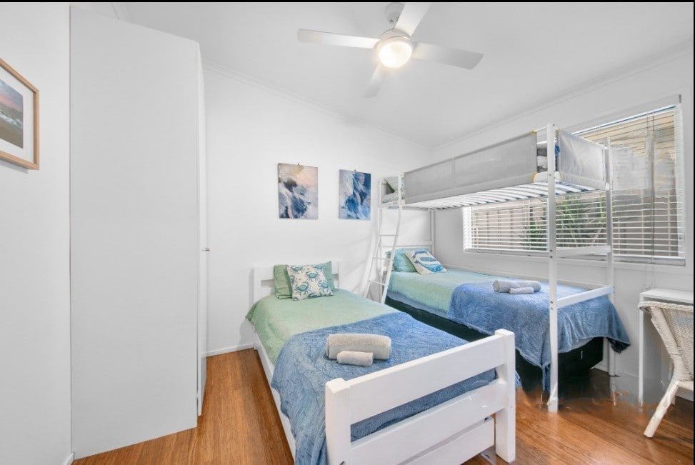 The loft bed has a single mattress at the top and a box spring/pillow-top at the bottom. There is also single bed. Children's study desk and chair. This room is tucked away behind two doors that block out noise.