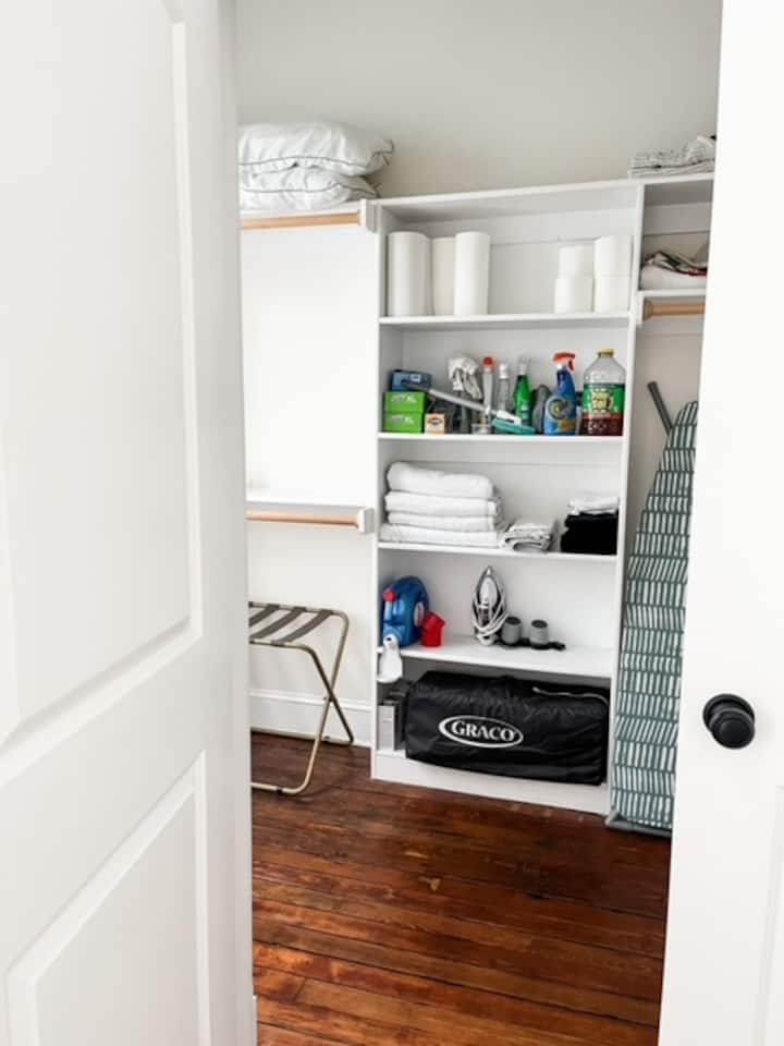 A look inside the master closet. We have a pack n play, sound machines, iron, laundry detergent, ironing board, extra towels, cleaning supplies, extra paper towels and toilet paper, all for your use during your stay. 