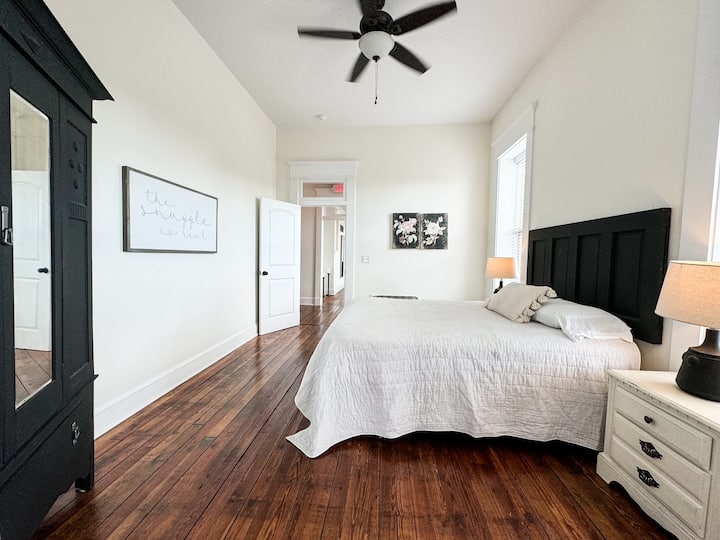 Another bedroom located right off the hallway with the living room on the other side.  Queen Bed and a wardrobe for hanging clothing. 