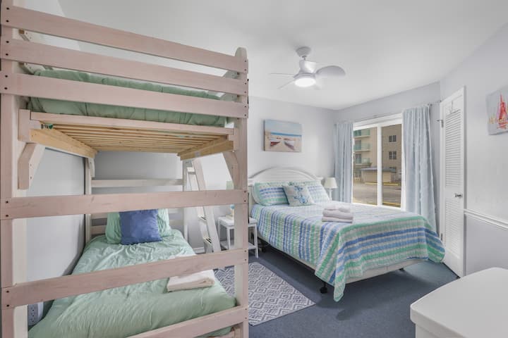 Perfect for families or friends, this bright room offers both a cozy queen bed and fun bunk space.