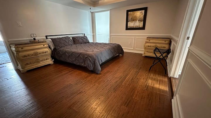 The downstairs bedroom has a king-sized platform bed with memory foam mattress and new pillows, a walk-in closet, and an en suite bathroom. An office is adjacent. Tell us if you need a portable crib or air mattress, and we'll put it in the closet.