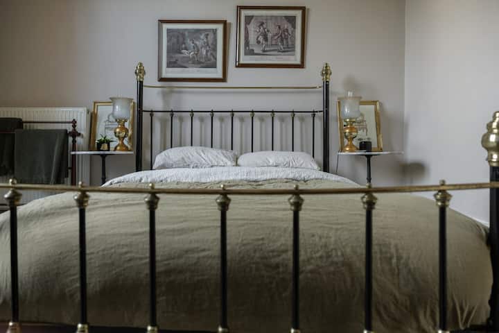 Our master bedroom offers a charming vintage bed, hotel quality mattress, goose down quilt & luxury French flax bedding linen. Light the open fire, draw the linen curtains and enjoy the perfect night's sleep.