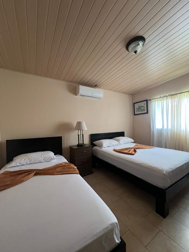 A relaxing nice clean bedroom with a/c night table  is essential for a good night's  sleep.we take very seriously here at villa Verde

