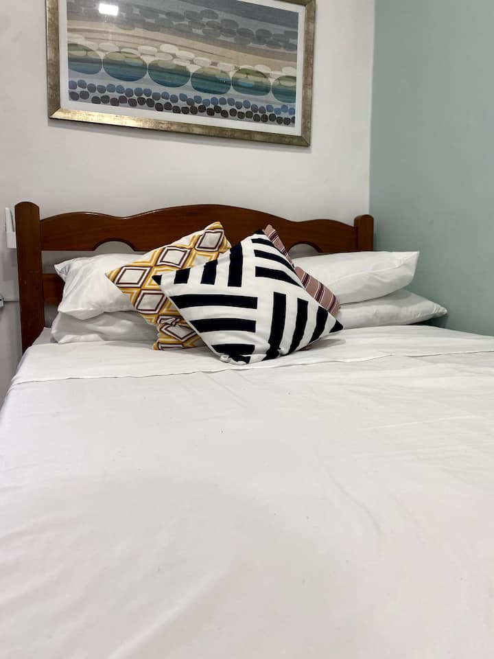 Room on the second floor that has a double bed and a sofa bed for two people. The room features air conditioning and a bathroom. 