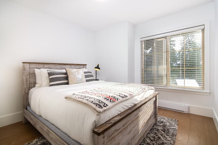 Third queen bedroom with a comfortable bed and easy access to the shared bathroom.