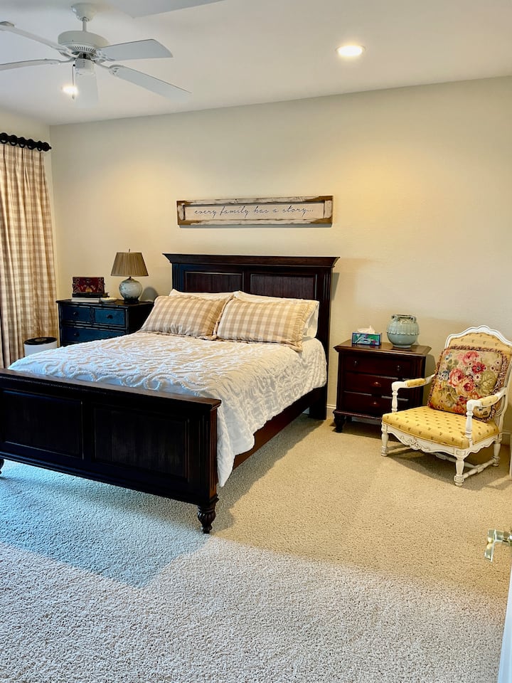 King bed, ceiling fan, private deck, private bathroom, closet, room darkening curtains.  TV.  Main floor.