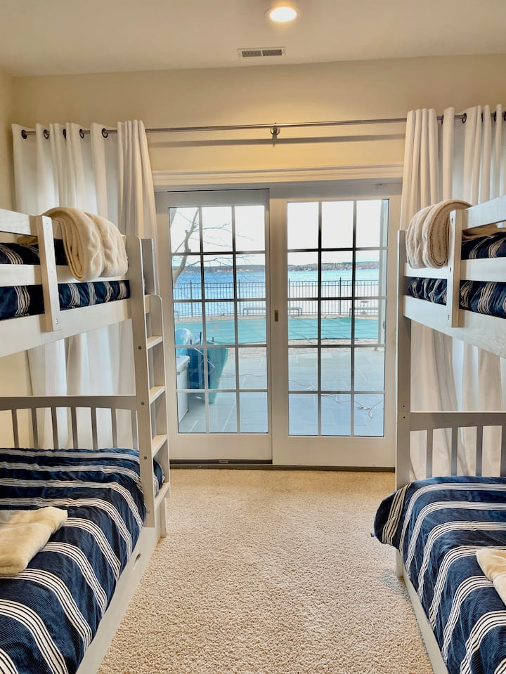 2 twin bunk beds, ceiling fan, private patio area, private bathroom, closet, room darkening curtains.  Bottom floor.