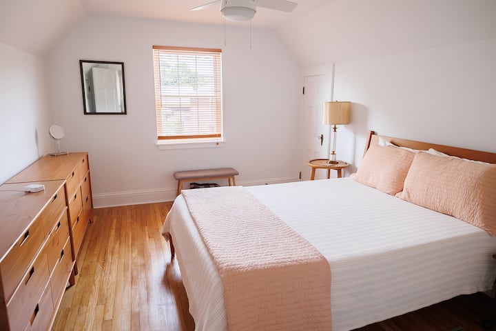 The third bedroom is upstairs, with a queen bed and resort sheets. It overlooks the front of the house. This is the largest queen bedroom in the house and has two dressers. 