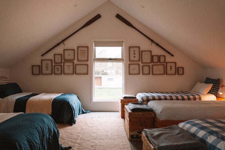 Huge fifth bedroom with 5 beds. Two King singles and three singles, directly adjacent to the upstairs lounge room.