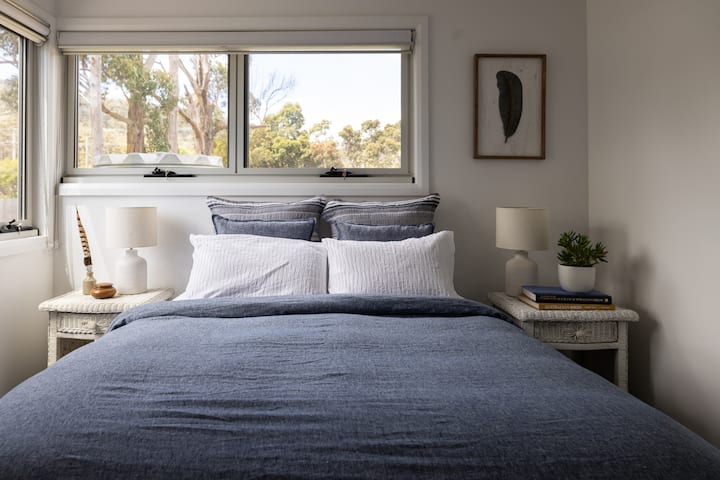 Bedroom 3 with water glimpses and blockout blinds.