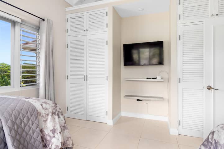 Cozy bedroom with smart TV and ample closet space