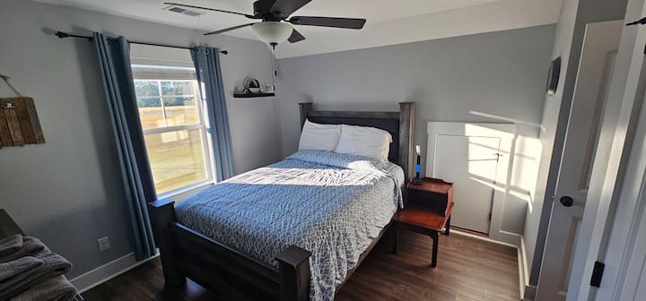 Bedside lamp, alarm clock, and charging station.