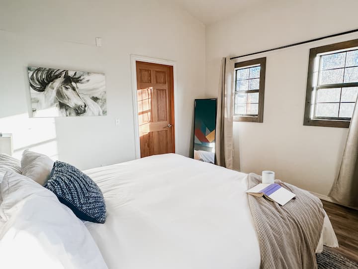 Primary bedroom with King Bed and comfortable Helix mattress, ensuite bathroom.  Note:  Bedroom is down a half flight of stairs.