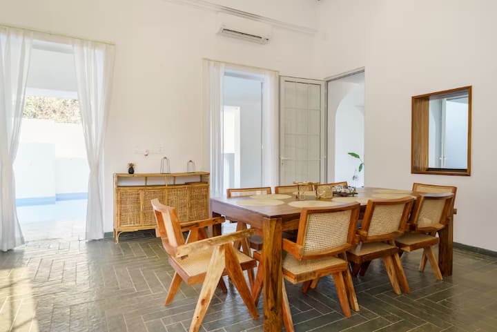 This elegant dining area is thoughtfully designed with ample space and comfortable seating, making i