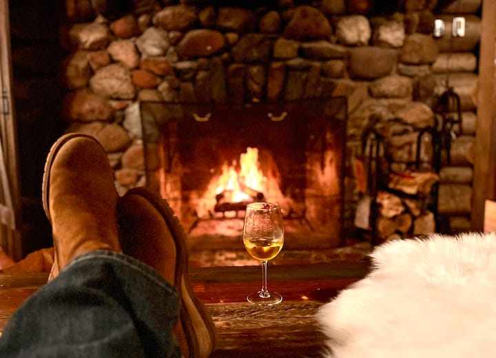 Experience the cozy warmth of the wood fireplace at North Shore Vacation Rentals, a pet-friendly retreat in Duluth, MN, accommodating 16 guests. Enjoy stunning waterfront views just 25 minutes from downtown, perfect for relaxation and exploration.