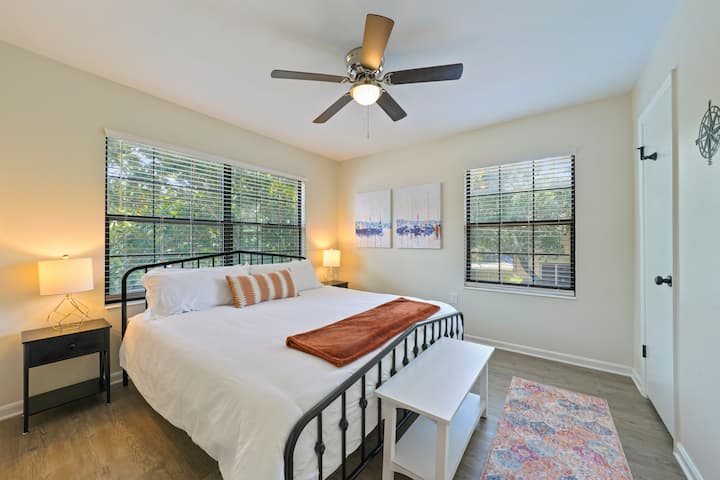 A minimalist bedroom with a bed and a ceiling fan. The perfect space for relaxation and creativity.