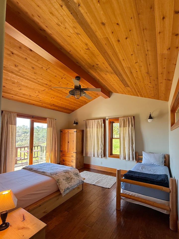 Interior of Clyde bungalow with queen bed and twin bed. 