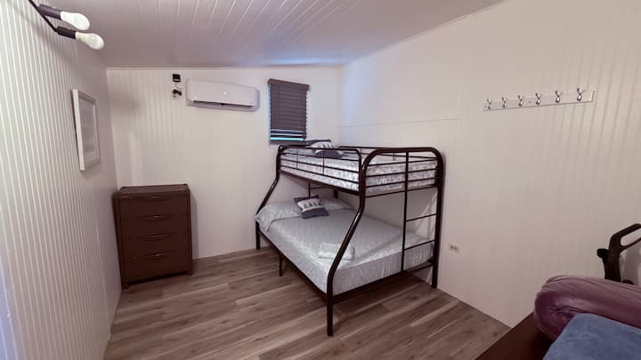 Perfect for families, this spacious second-floor room at Cabañas Muelle features comfortable bunk beds, ensuring a restful night's sleep after a day of fun in the sun. Enjoy the cool comfort of air conditioning.
