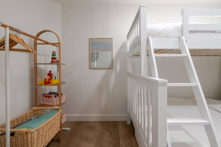 This valet stand provides hanging and shelf organization for the 2nd bedroom, & Robert Smith lyrics to inspire your day of adventuring. The home is also equipped w/ a new (June 2023) Pack 'n Play portable crib & Crate & Barrel organic crib bedding.
