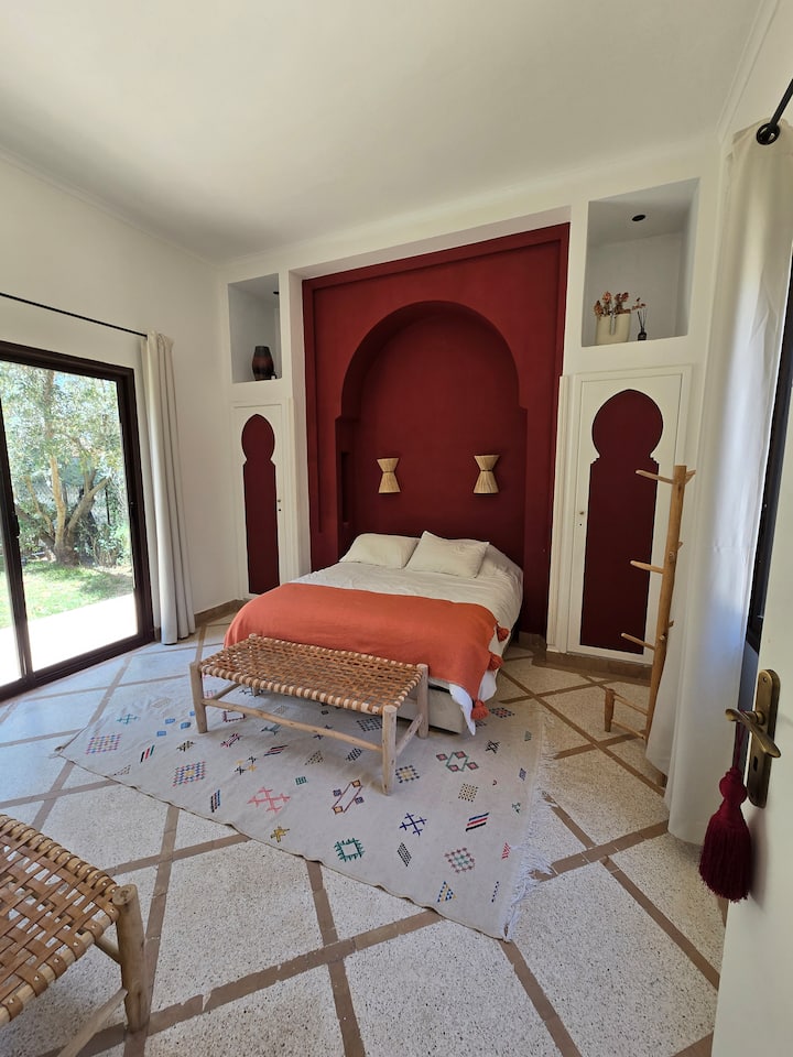 Suite roja «Ahmar», con una superficie de 22 m², ubicada en la planta baja y abierta al jardín trasero, con baño equipado con regadera.