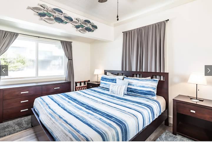 The main floor houses the primary bedroom with an ensuite bath, also containing a washer and dryer. With its king size bed and premium linens  it's a sure fire favorite.