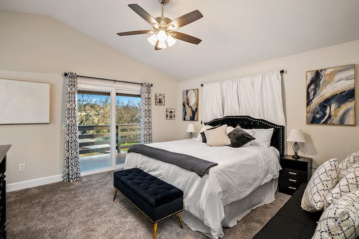 Master bedroom with a king size bed, sofa bed, and floor mattress.  