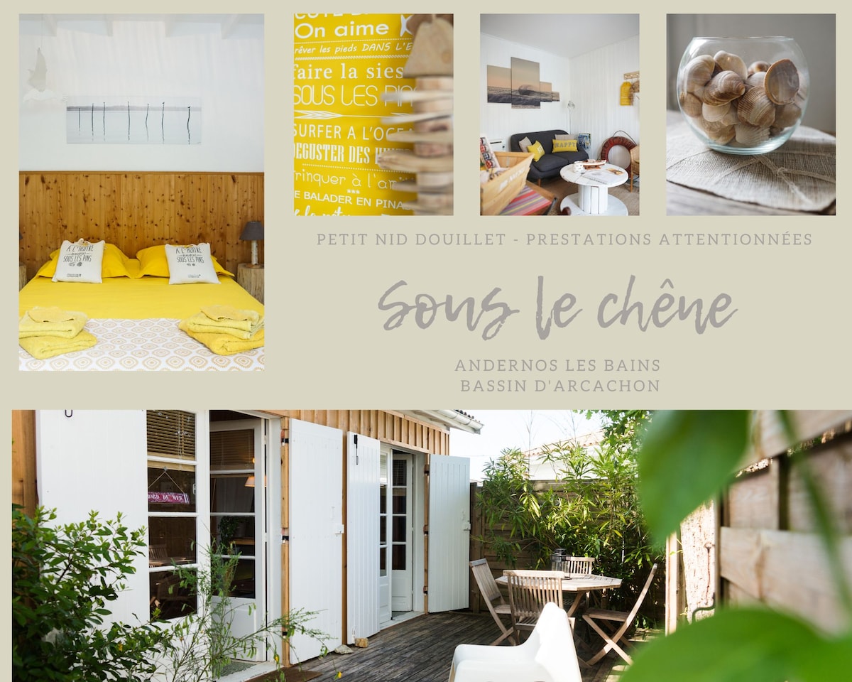 A cozy living space features a warm, wooden accent wall and a generous, inviting bed with yellow linens. Bright natural light floods the area, accentuated by stylish decor elements. Outside, a private terrace with garden furniture creates an ideal spot for relaxation.