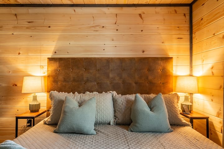 Experience the pinnacle of comfort on our king-size bed with a cloud-like 12" Memory Foam Mattress. Plush pillows enhance the coziness, and the built-in charging device for phones adds a modern touch to your serene retreat.