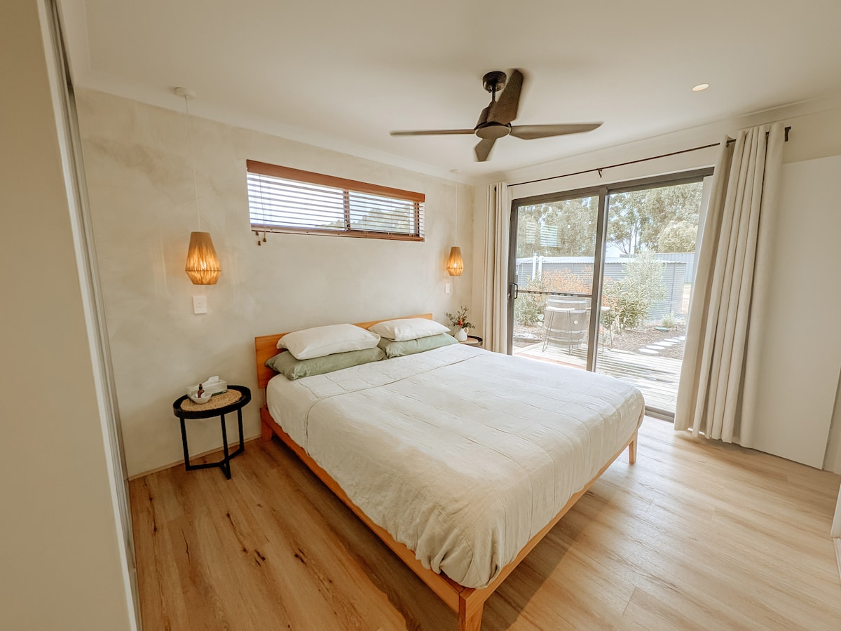 Step into serenity as your bedroom opens up to a private deck. Sink into the comfort of a king-sized bed with soft flax linen, complete with Cloud Collection king-sized pillows & mattress topper. Relax in this cozy retreat after a day of adventure.