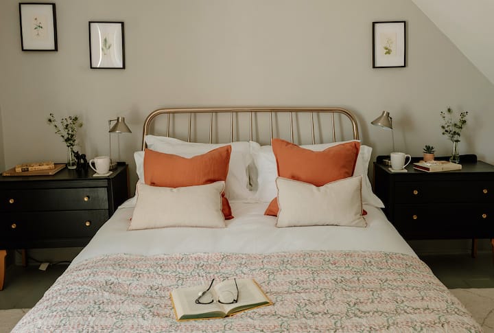 King bedroom with antique painted side chests, a modern gas fire and discreet wall mounted tv. Views to the front of the house. 
All king bedrooms have sumptuous linens and pretty hand printed throws.