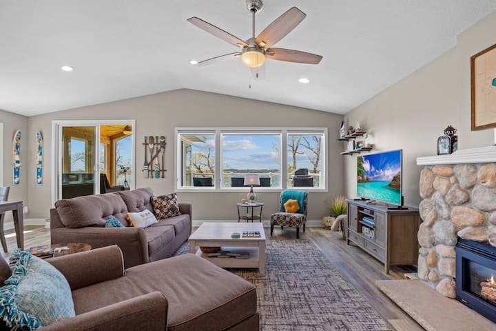 Open concept living room with gas fireplace, smart TV and sleeper sofa