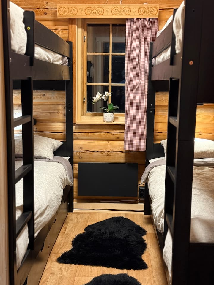 Bedroom Energy has four beds divided into two bunk beds with bed size 75 x 200 cm. The room has a window to the east with a blackout curtain. There are 4 spacious wooden storage boxes under the beds as well as several hooks. Here also nice sheepskin on the floor.