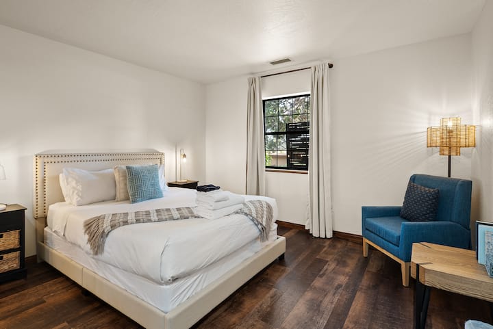 Bedroom 4, also featuring a cozy reading nook, features a plush queen-sized bed with luxury, hotel-grade linens