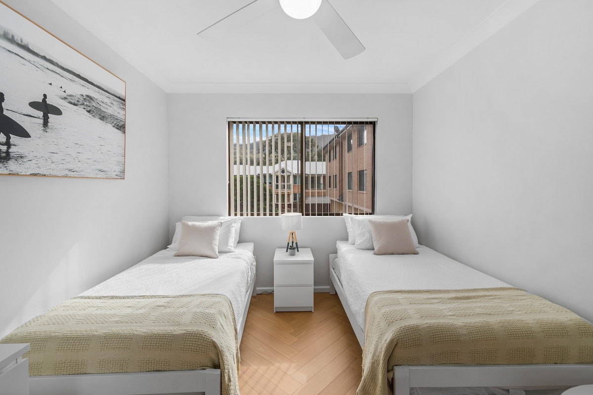 Ideal for families or friends, the third bedroom offers two comfy king single beds, soft throws, and a surf-inspired artwork.
