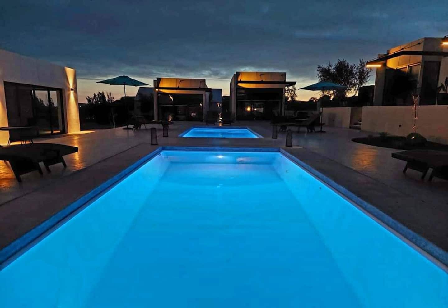 The main pool lit at dusk