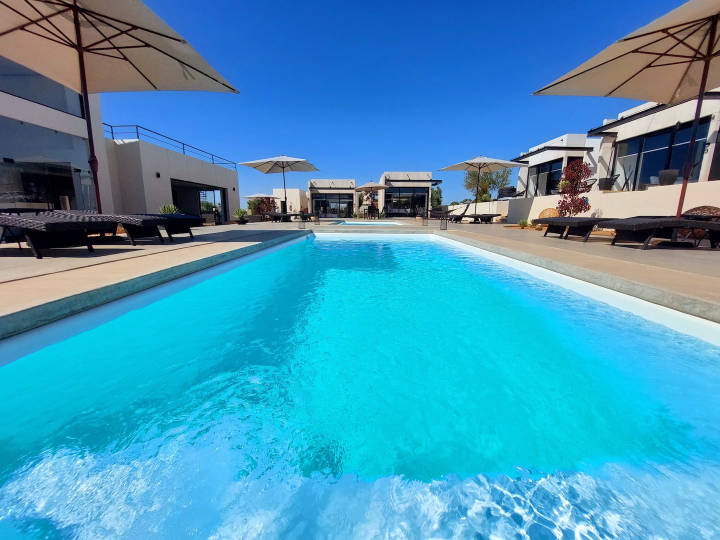 The main pool, with loungers and umbrellas along both sides