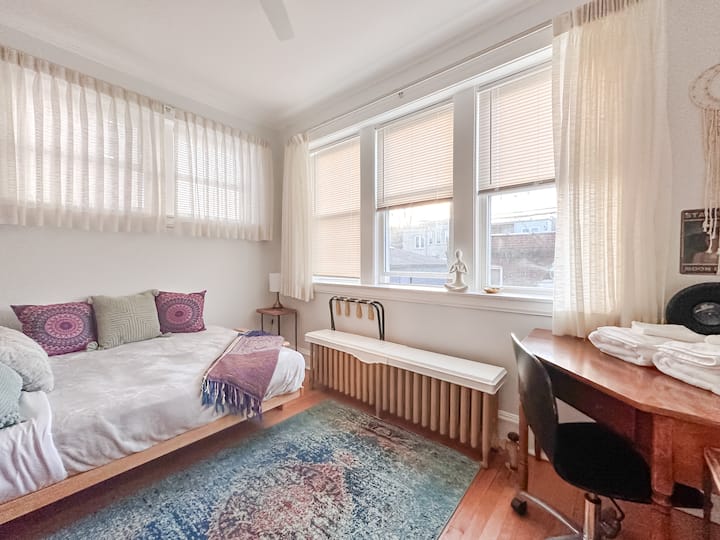 This is the rear bedroom, separated from the kitchen by a thick curtain over the doorway.