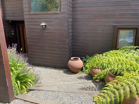 Comfortable house with a large gazebo and a wood-burning stove.