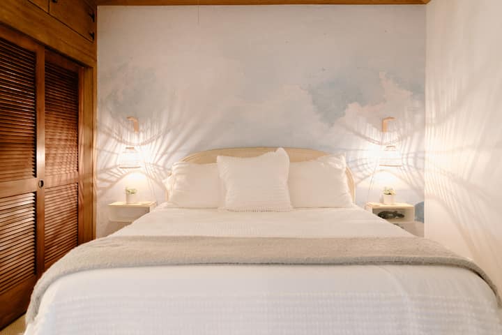 King sized bed in the bedroom has a new Casper Select memory foam mattress + crisp white West Elm and Casaluna bedding.