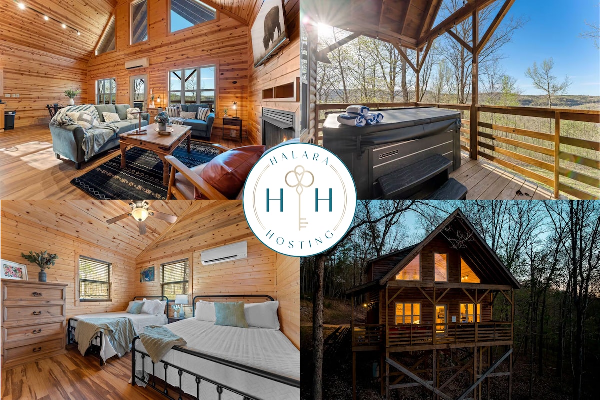 The spacious cabin interior features warm wooden walls and large windows that allow natural light to fill the living area. A hot tub is visible on the deck, which overlooks the scenic wooded surroundings. Cozy sleeping areas with neatly arranged beds emphasize comfort and relaxation.