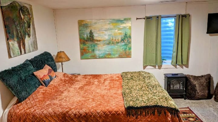 
"The Range" is the name of this fun bedroom which features a comfy Queen-sized bed and a full futon. The natural colors and artwork add whimsy to the cozy space. (Check out the painting: Bob Ross Buffalo:)