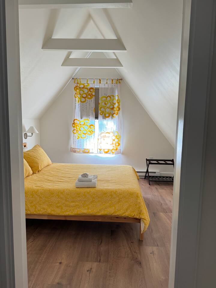 For reference- I smack my head against the sloped ceiling on occasion and I'm 5'-5" We get told a lot by guests from Europe that this is not a small room at all. Room size is subjective depending on what you're used to!