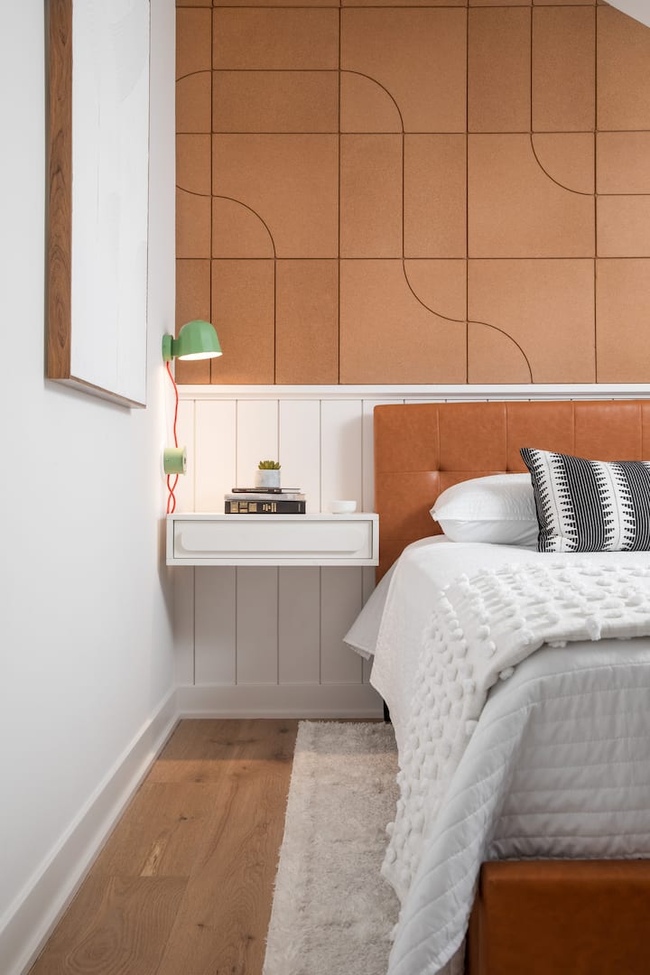 Secondary bedroom is loaded with fun design, like the lamps and cork wall