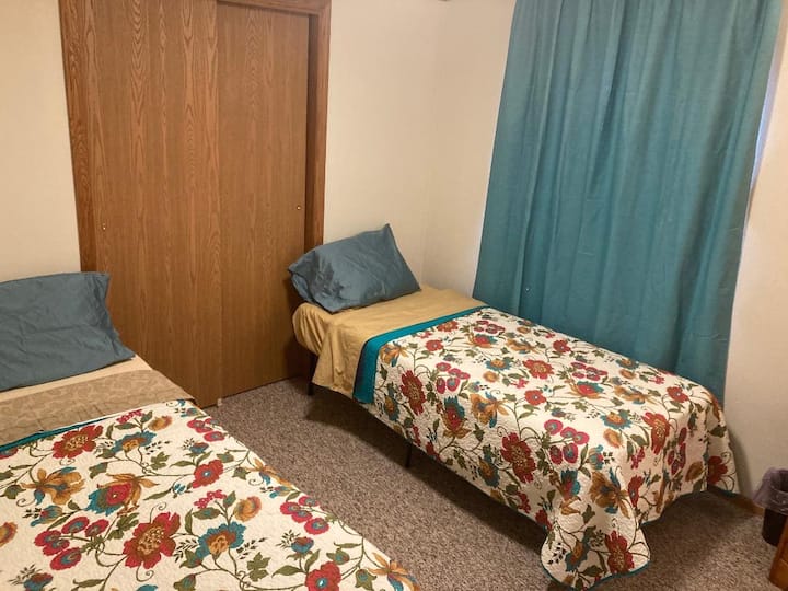 This is the smallest bedroom. It has two twin beds that can be put together to make a king size bed. It has an on-suite bathroom with a stall shower. 