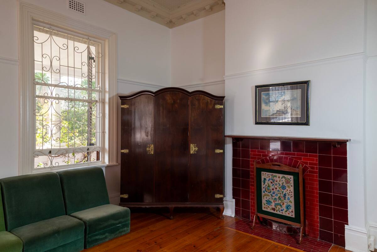 Tiled Victorian fireplace and wardrobe inside the fireplace room at Utopia Cape Town