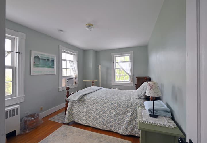 A cozy double bed at the top of the back stairs.  With three windows you have the farm view and you overlook the pond.  Nothing escapes your view!