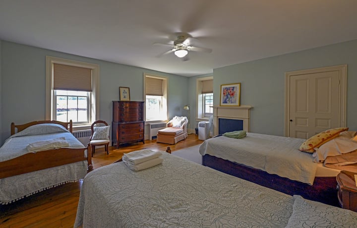 A family bedroom from design, be it your family or a sleepover with friends. 
 Tucked at the top of the front stair and adjacent to the bathroom, it's quiet and nestled a few steps from the other bedrooms.