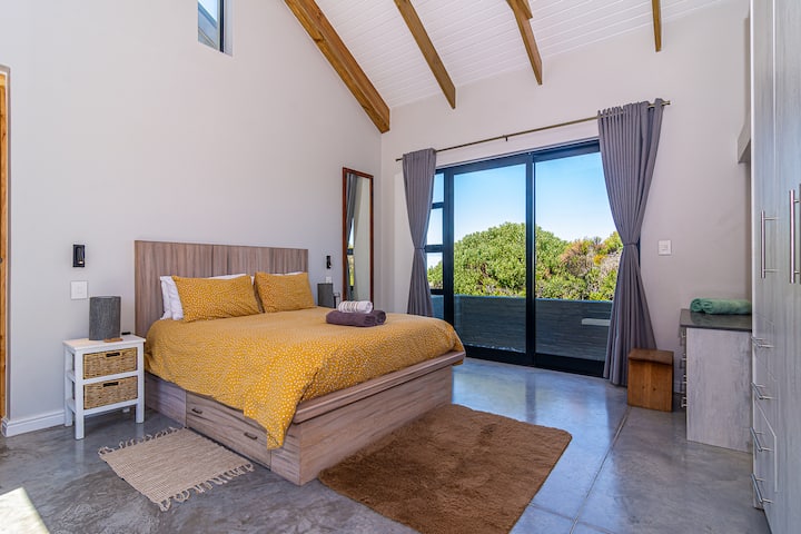 Bedroom #1 - Queen size bed. En-suite bathroom. Sliding doors opening to outside.