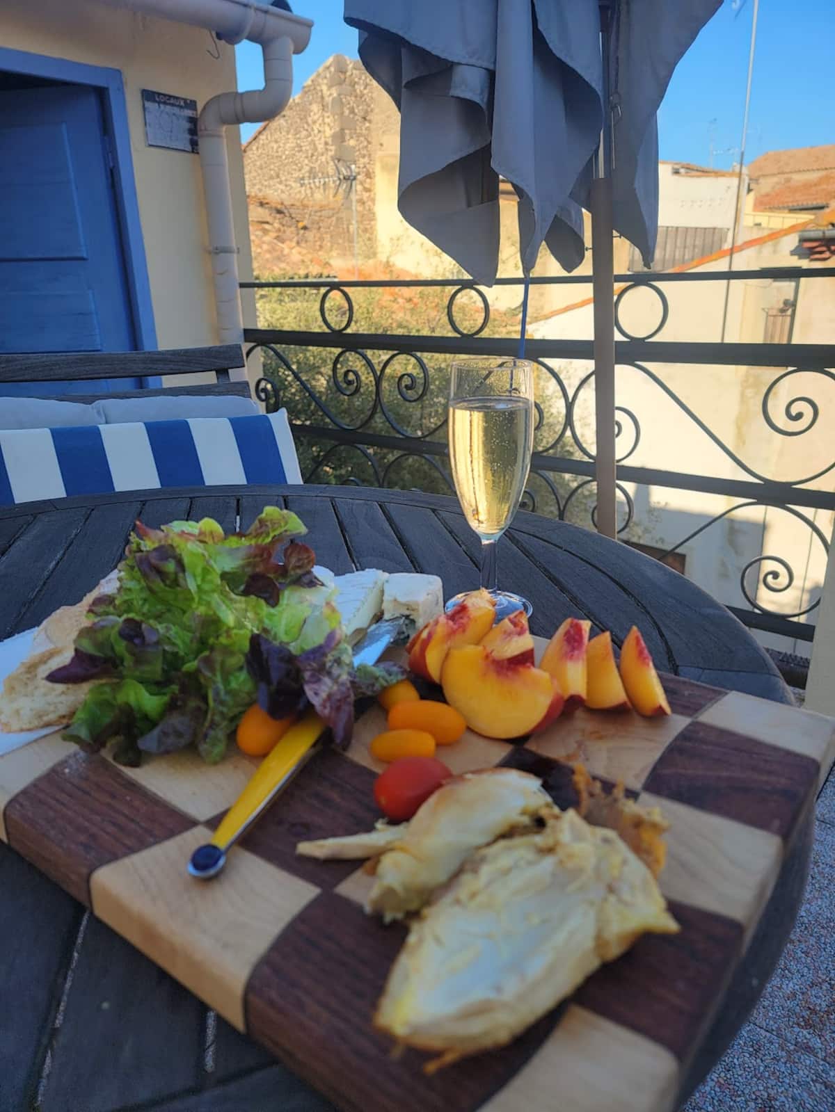 A generous sharing board with bread and wine on the Maison Embonne rooftop terrace